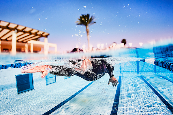 Mand svømmer baner i olympisk pool på Playitas Resort